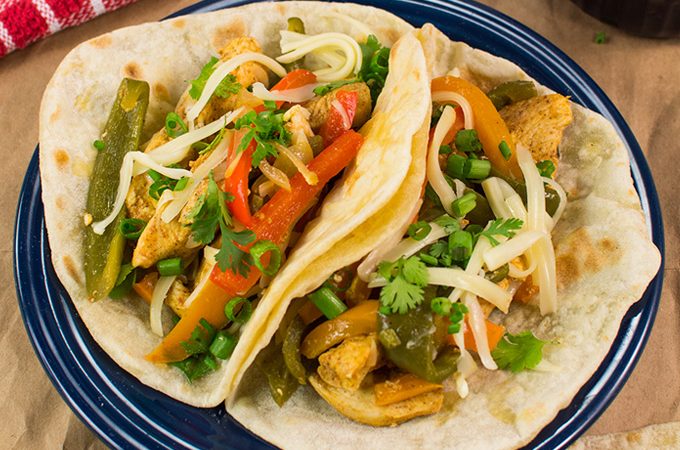 These chicken fajitas are made with strips of chili-lime seasoned chicken breast, tossed with vibrant peppers, onions, and wrapped in warm flour tortillas.