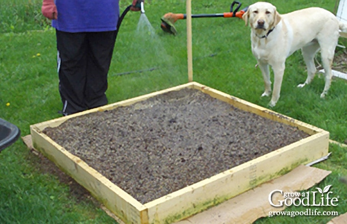 image of a square foot garden filled with fresh soil)