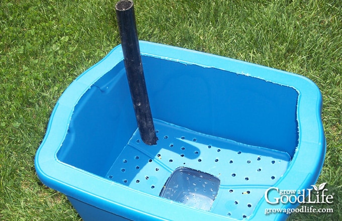 Fill tube inserted vertically through the aeration shelf into the water reservoir.
