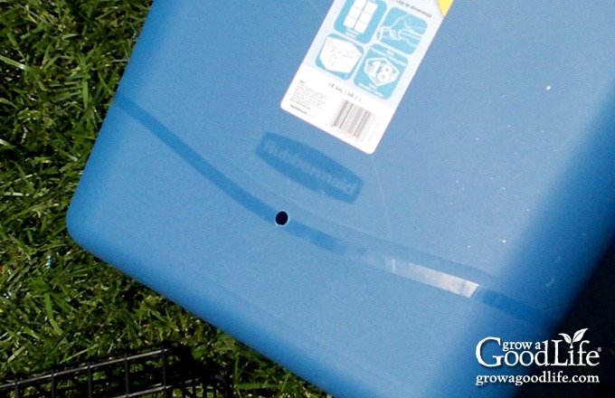 A 1/4-inch overfill hole in the side of the tote below the aeration shelf.