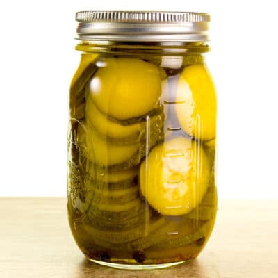 jar of zucchini pickles on a table