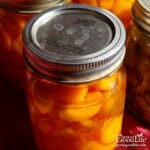jar of home canned carrots on a table