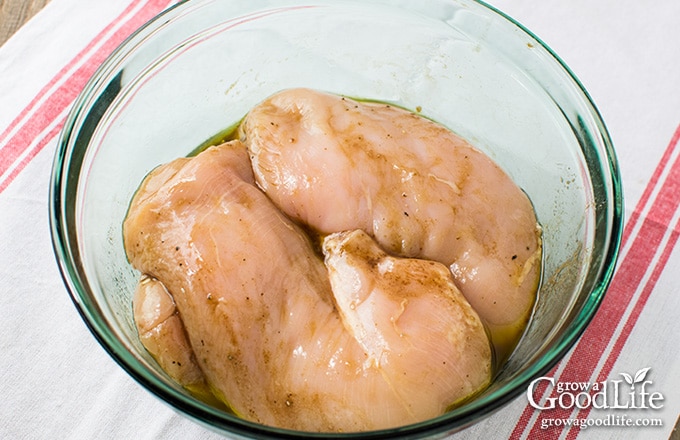 chicken marinating in a bowl