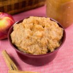 maroon bowl of applesauce on a table