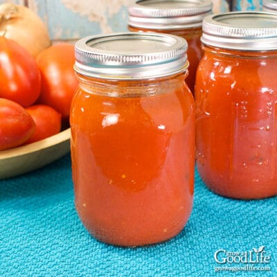 jars of home canned tomato sauce on a table