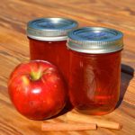 This spiced apple jelly recipe livens up the plain apple flavor with some traditional pairings including lemon juice, cinnamon, cloves, and allspice.