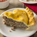 Tourtière, also known as pork pie or meat pie, is a traditional French-Canadian pie served by generations of French-Canadian families throughout Canada and New England. It is made from a combination of ground meat, onions, spices, and herbs baked in a traditional piecrust.