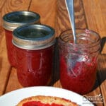 jars of chokecherry jelly on a table