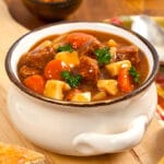 white bowl of beef stew on a table