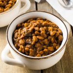 With a few simple ingredients and time, you can make a delicious, slow cooked New England baked beans dinner.