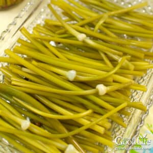 Pickled garlic scapes served on a pickle tray.