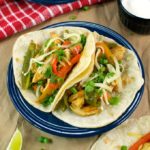 These chicken fajitas are made with strips of chili-lime seasoned chicken breast, tossed with vibrant peppers, onions, and wrapped in warm flour tortillas.