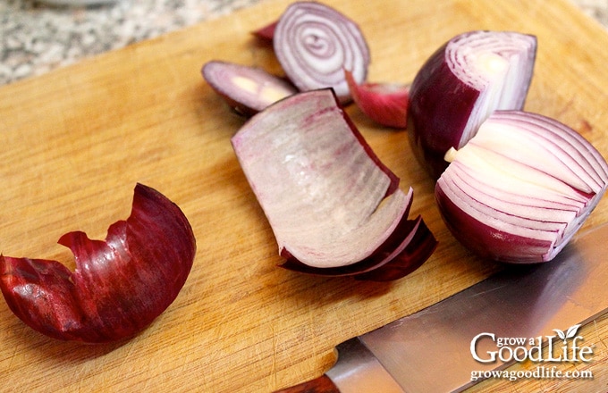 red onion sliced in half on a cutting board