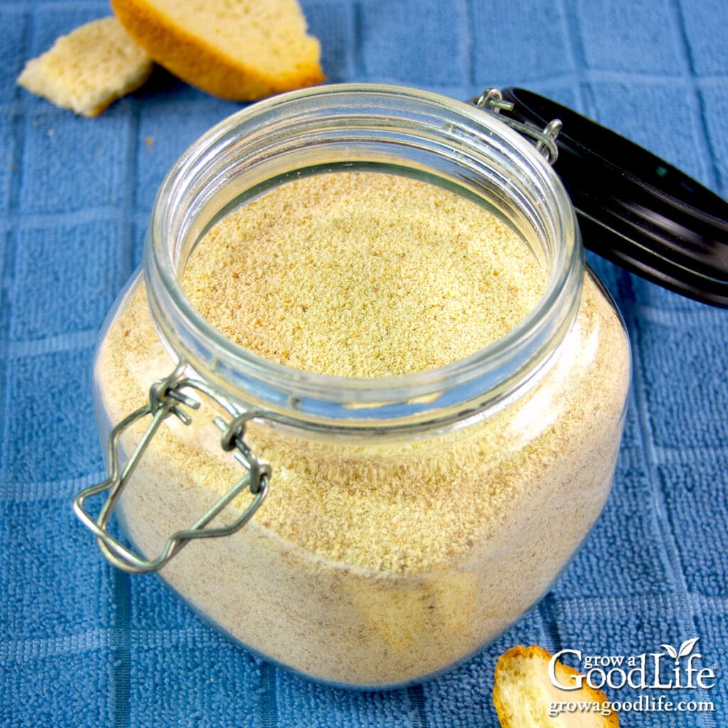 Open jar of homemade dried bread crumbs on a kitchen table.