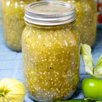 jars of tomatillo salsa verde on a blue towel