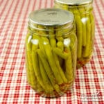 jars of pickled dilly beans on a table