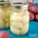 jars of home canned potatoes on a table