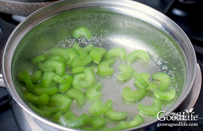 celery pieces in a pot of boiling water