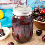 jar of canned bourbon cherries on a table