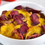 gold and red beet chips in a white bowl