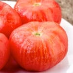 peeled tomatoes on a plate pic