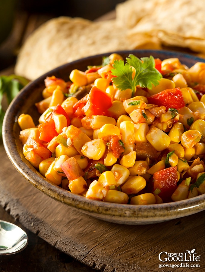 closeup of a bowl of corn salsa on a table