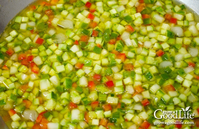 chopped cucumbers, onions, and peppers soaking in pickling brine