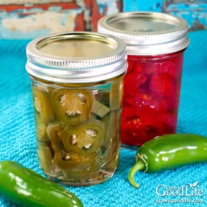 Jars of home-canned pickled jalapeños made with red and green peppers.