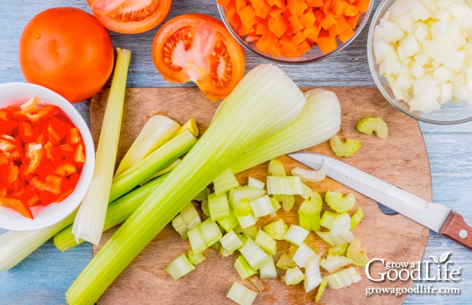 cutting board with chopped celery and vegetables