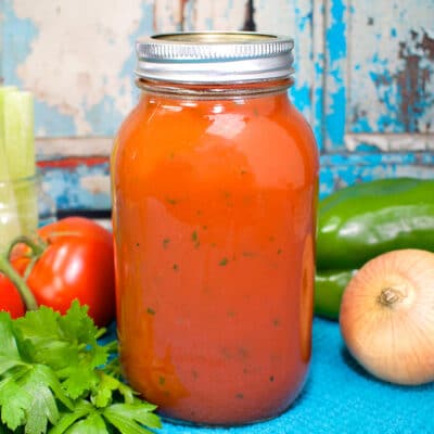quart jar of tomato vegetable juice on a blue towel