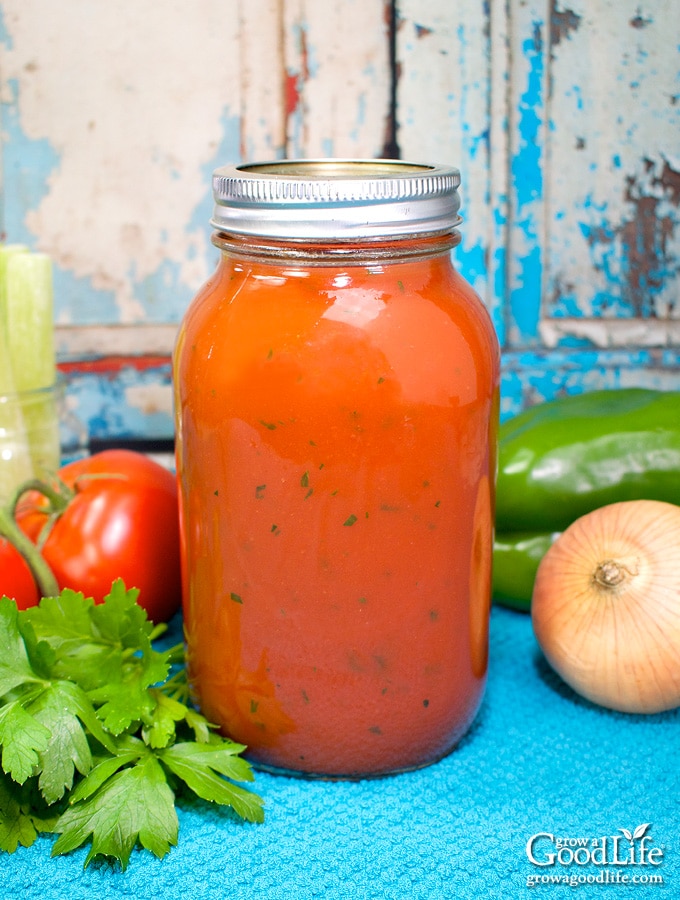 quart jar of tomato vegetable juice on a blue towel