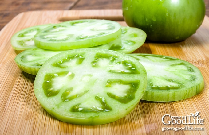 slices of green tomatoes on a cutting board