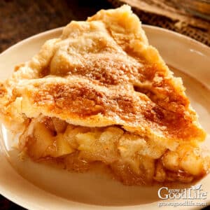 A slice of homemade apple pie on a table.