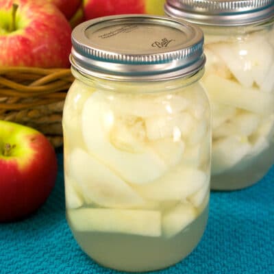 jars of canned apples on a table