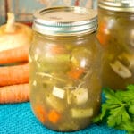 jars of canned chicken soup on a blue towel on a table