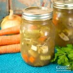 jars of home canned chicken soup on a table