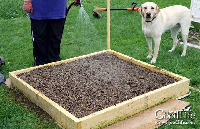 4×4 square foot garden bed filled with freshly mixed soil.