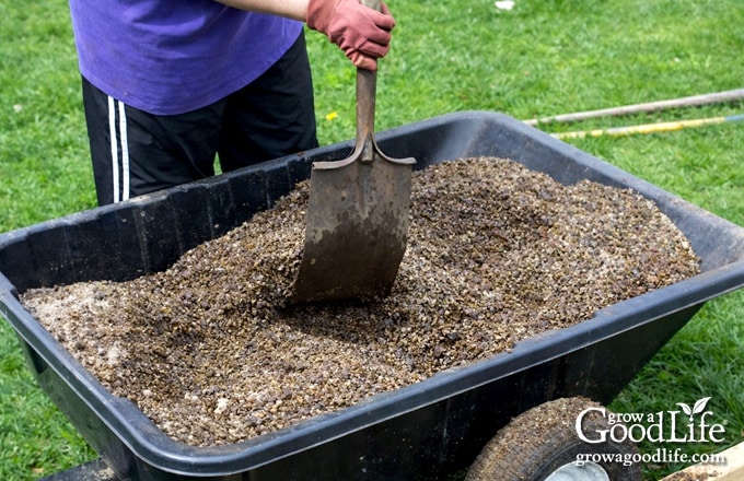 Mixing square foot gardening soil blend in a garden cart.
