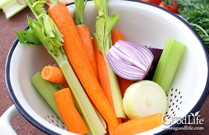 chopped celery, carrots, and onions in a white bowl