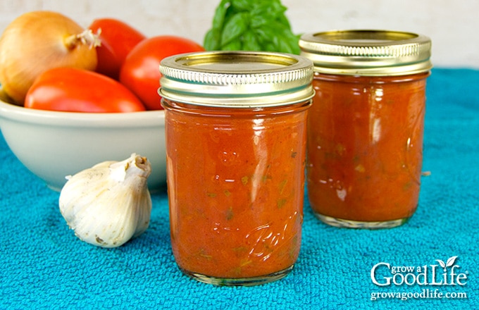tomato sauce in pint jars on a towel, roma tomatoes, basil