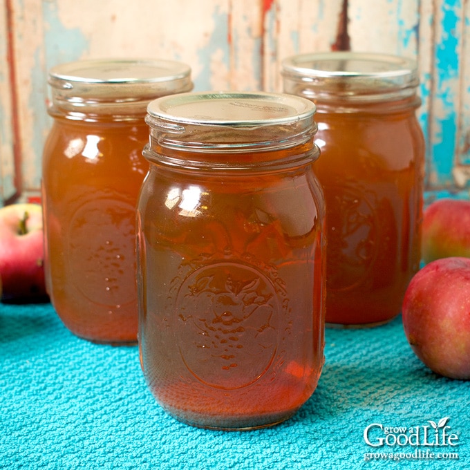 jars of canned apple juice on a table