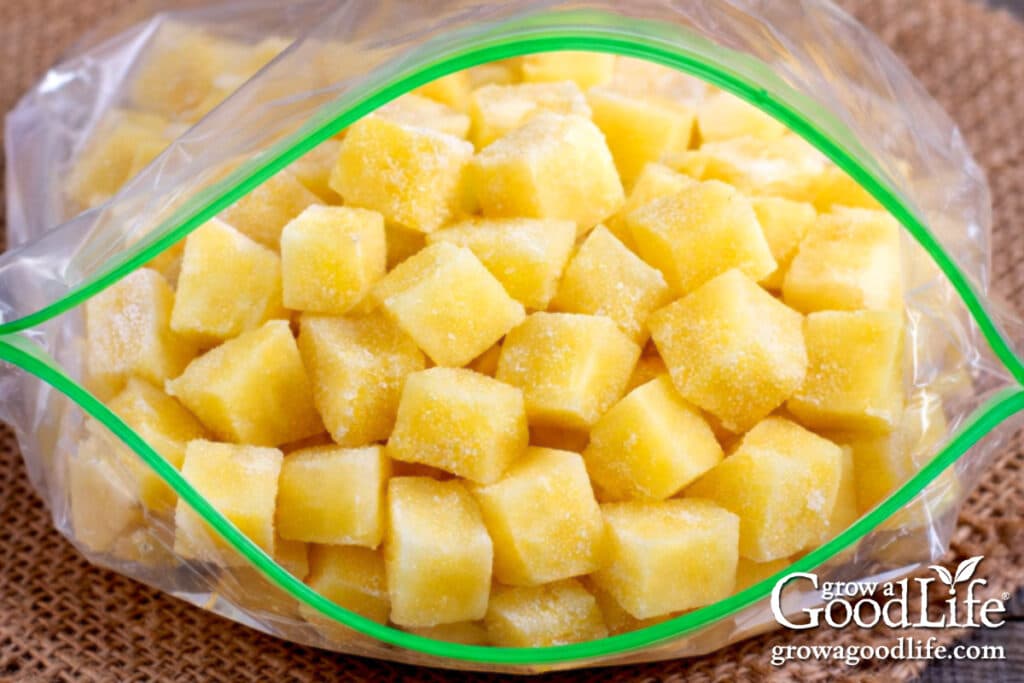 Cubed potatoes frozen in an open freezer bag for long-term storage.