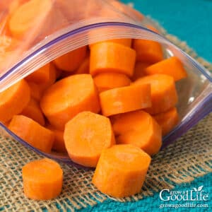 Freezer bag filled with sliced carrots ready for freezing.