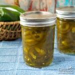 jars of candied jalapenos on a table