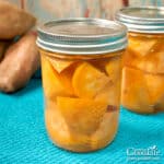 jars of home canned chunks of sweet potatoes on a table