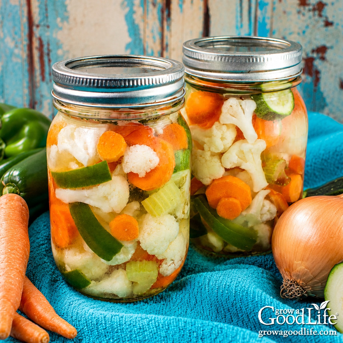 Jars of home-canned giardiniera pickled vegetables with cauliflower, carrots, peppers, celery, and zucchini.