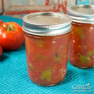 jars of homemade rotel tomatoes and green chilies on a table