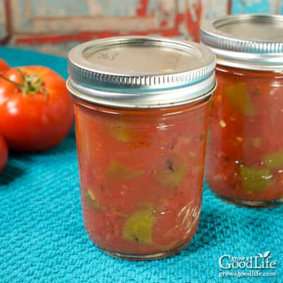 jars of homemade rotel tomatoes and green chilies on a table