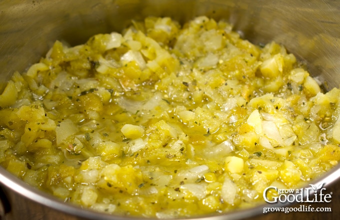 Green tomato salsa simmering in a large pot.