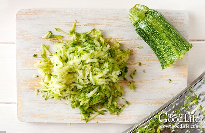 Shredded zucchini on a cutting board.